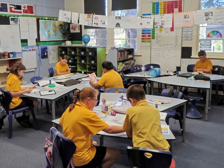 Students working at their desks in the classroom.