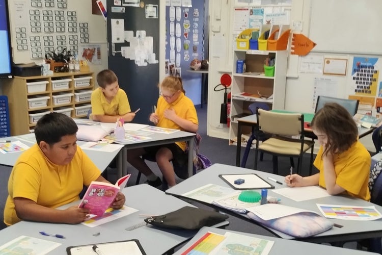 Four students learning in the classroom.