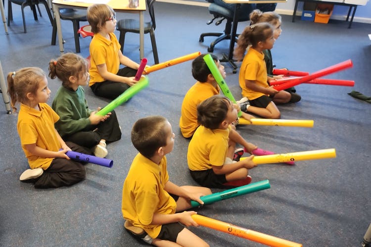 Students using Boomwhackers.