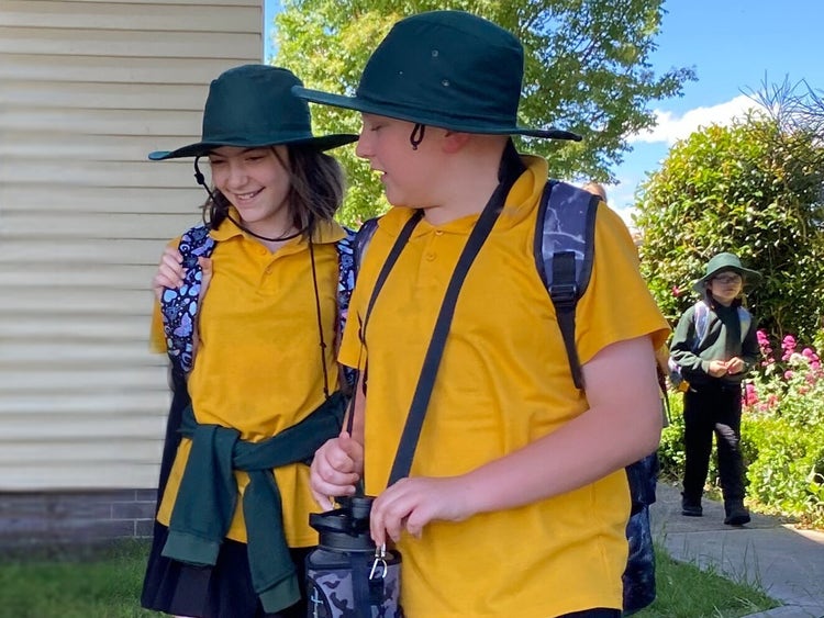Students talking as they head to the bus stop.
